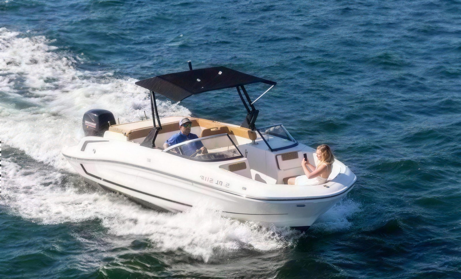 Speed boat with a black canopy cruising on San Diego Bay
